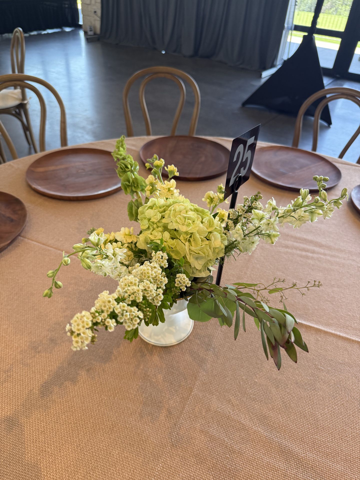 Airy green hydrangea and bells of Ireland centerpiece on a wedding reception table