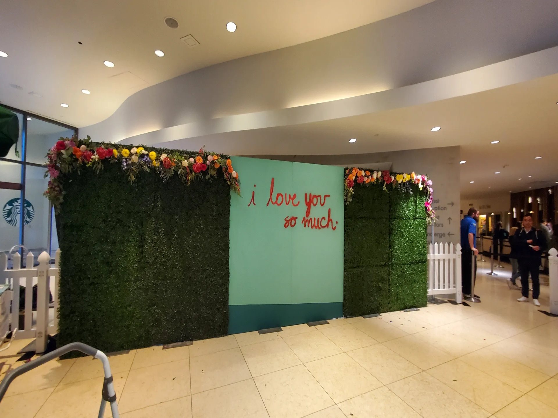 Boxwood hedge wall with florals as a corporate reception photo backdrop