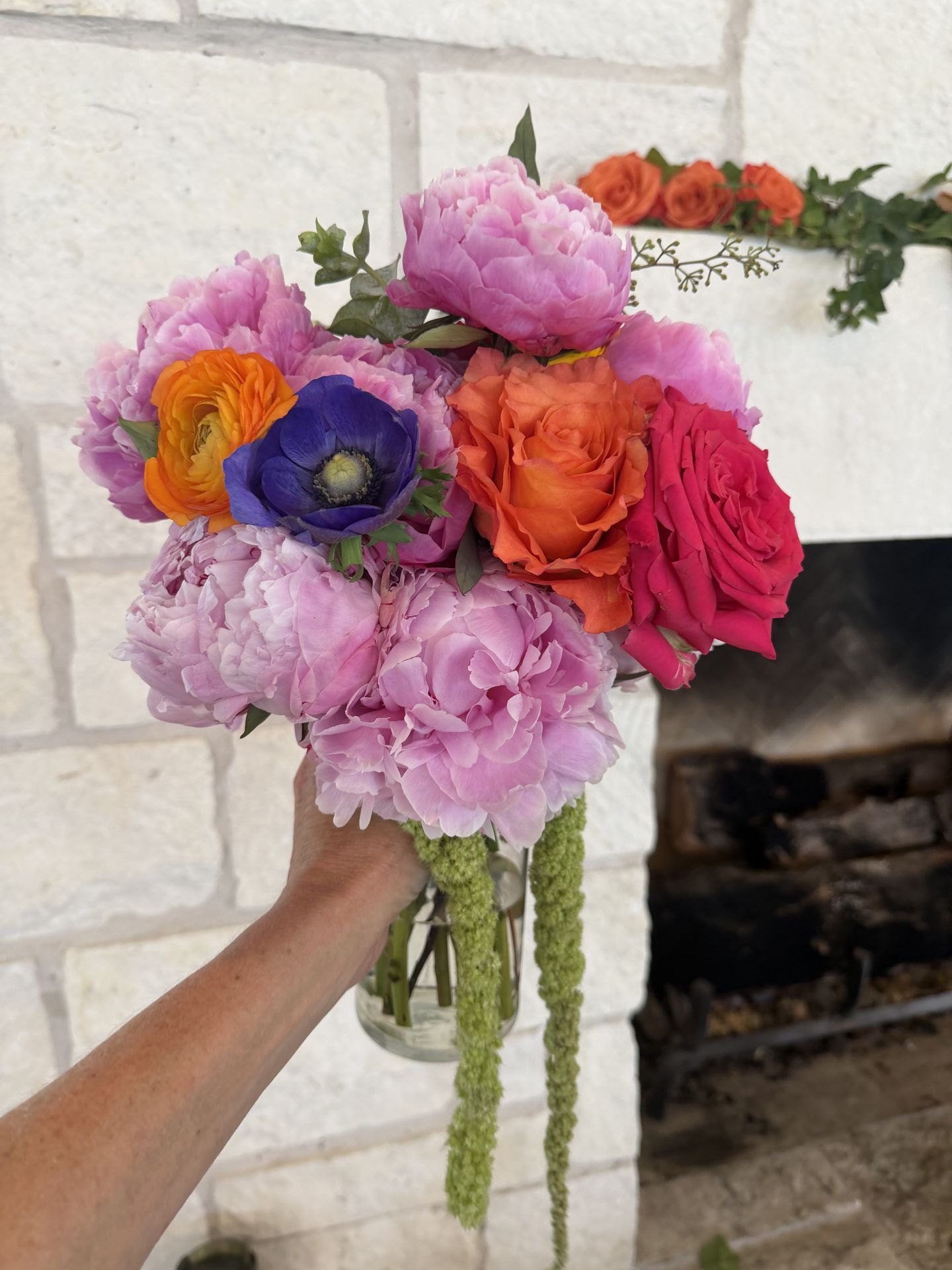 Pink peony bridal bouquet with coral roses and trailing amaranthus