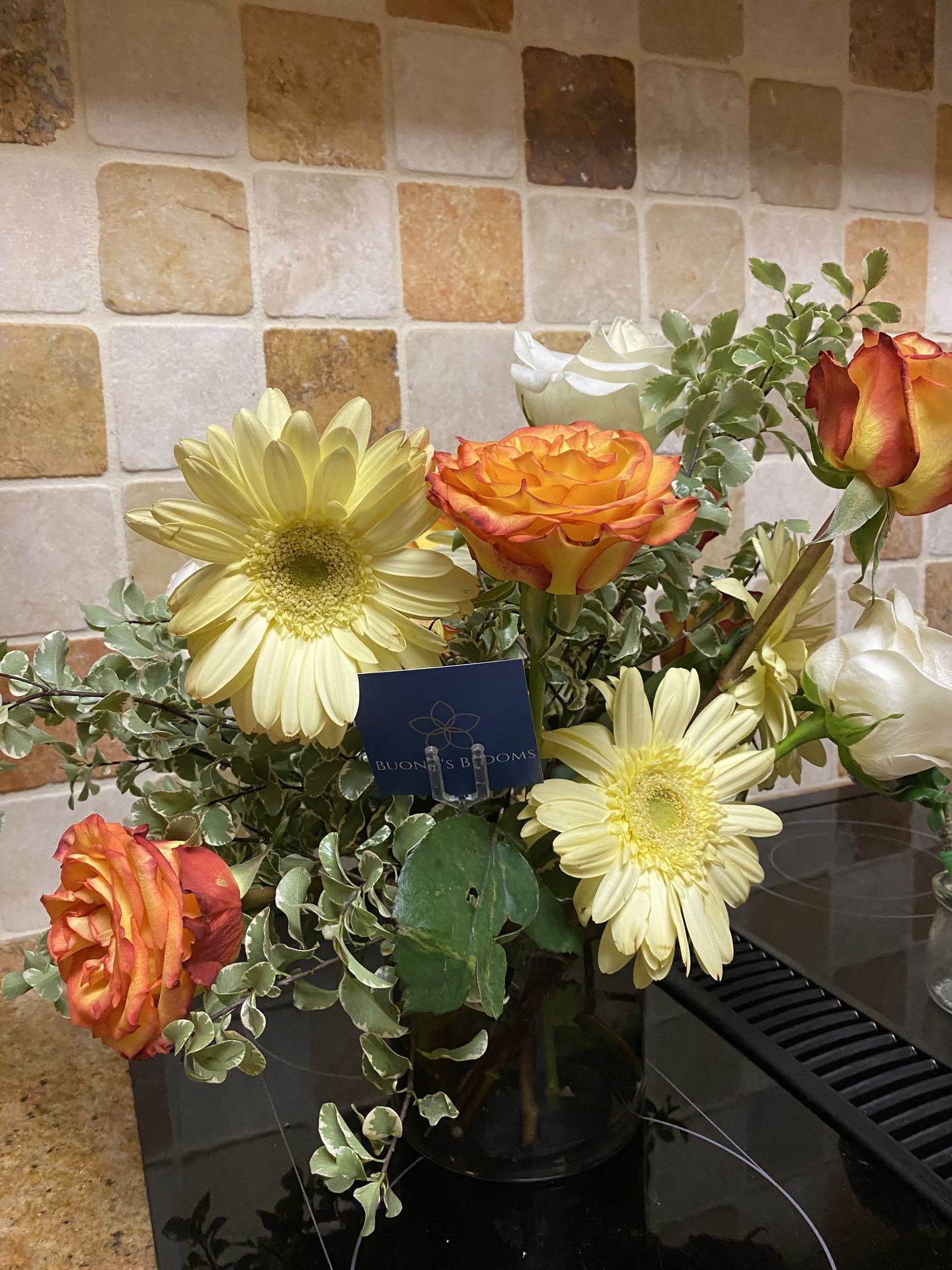 Golden gerbera daisies and fiery bicolor roses — a Texas nod in yellow blooms, vibrant and beautifully contextual for Austin events.